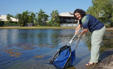 Mayor Athina Pascoe-Bell releasing fish into Lake 10