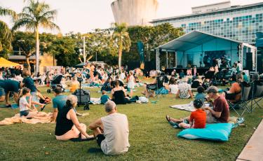 Community sitting on grass at Goyder Square 