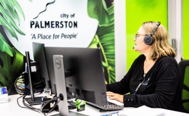 Image: CoP staff member at front desk typing