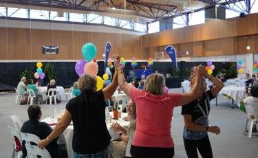Image: Seniors with arms in the air 