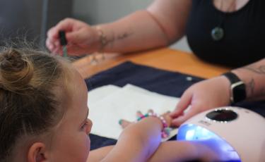 Image: small girl getting nails done