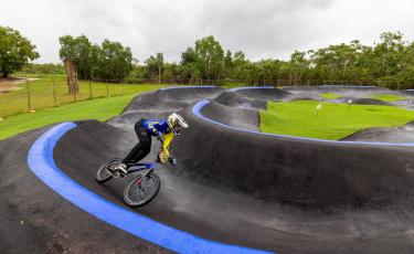 A young boy riding the bike at Zuccoli Pump track