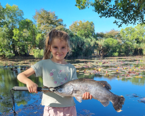little girl holding fish
