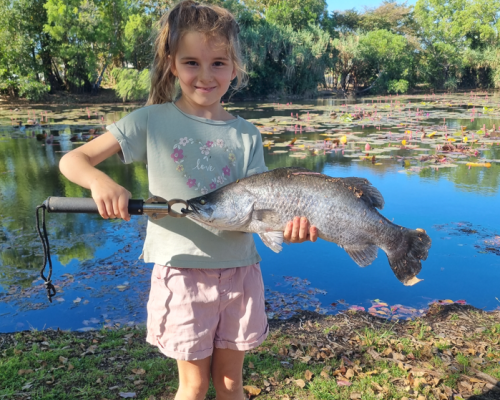 little girl holding fish