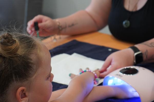 Image: small girl getting nails done