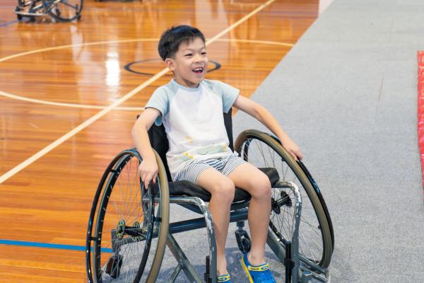 image: boy in wheelchair smiling 