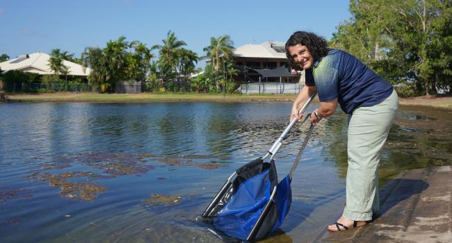 Mayor Athina Pascoe-Bell releasing fish into Lake 10