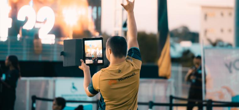 Image: Boy with rock symbol in the air filiming 