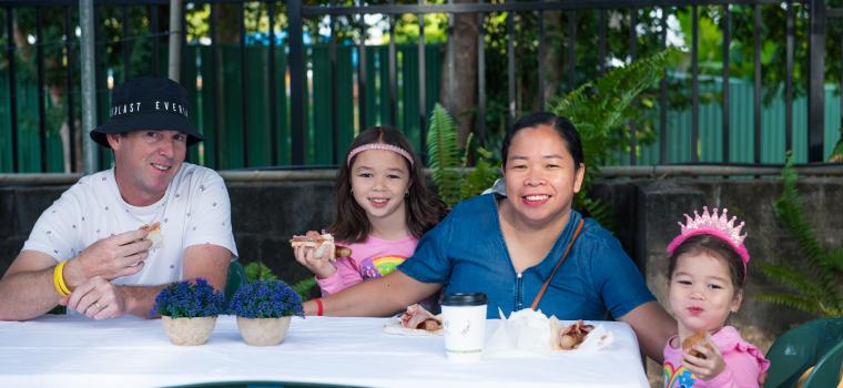 Image: family smiling and eating at Gray