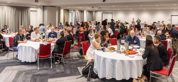 image of businesses sitting around tables 